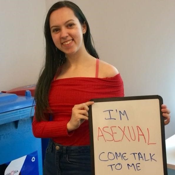 A student and a signboard help raise awareness on asexuality